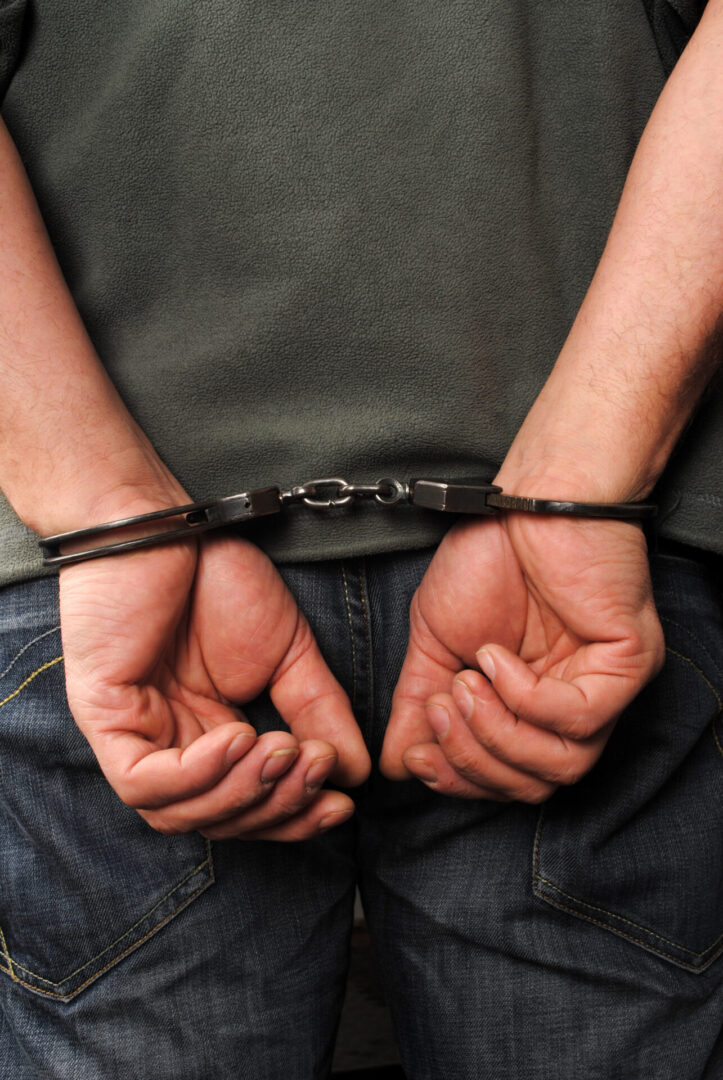 Person handcuffed with hands behind back