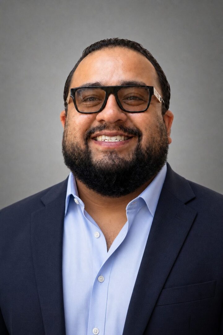 Smiling bearded man in suit and glasses