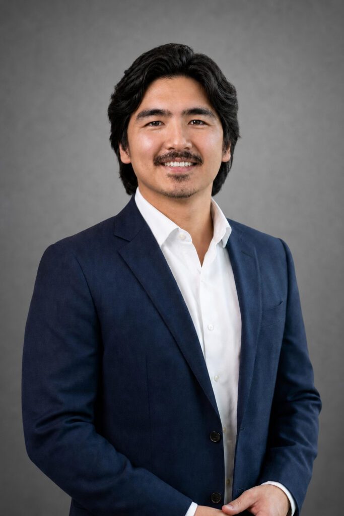 Smiling man in navy suit studio portrait